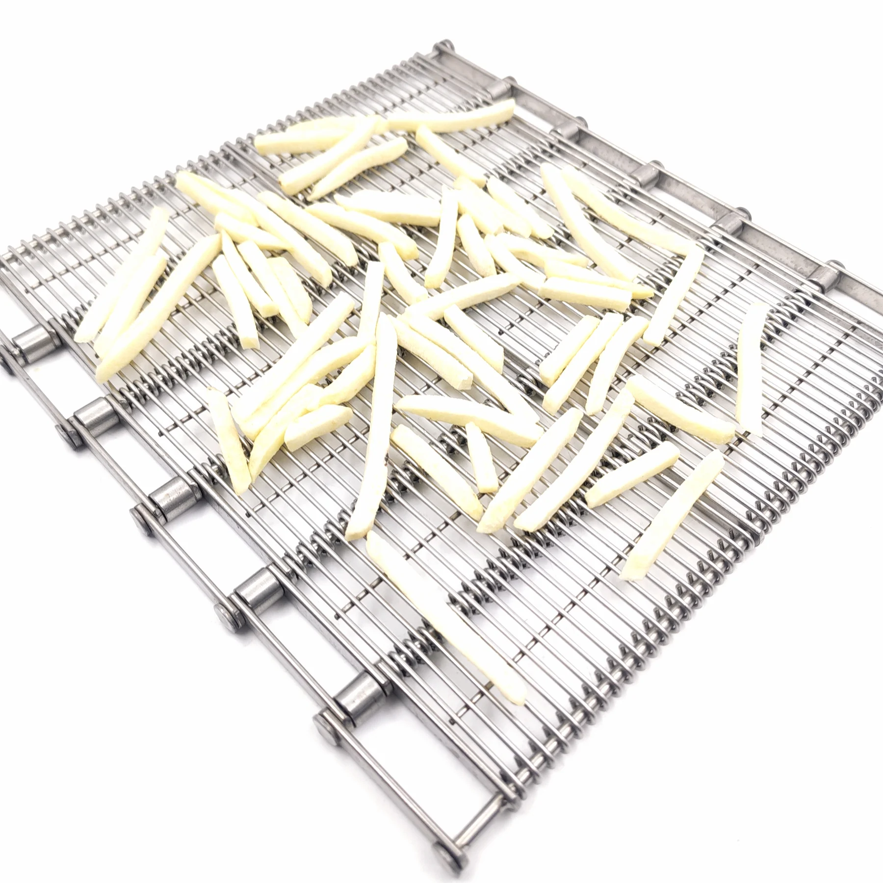 Pale cut potato strips arranged on an open linked metal conveyor belt.