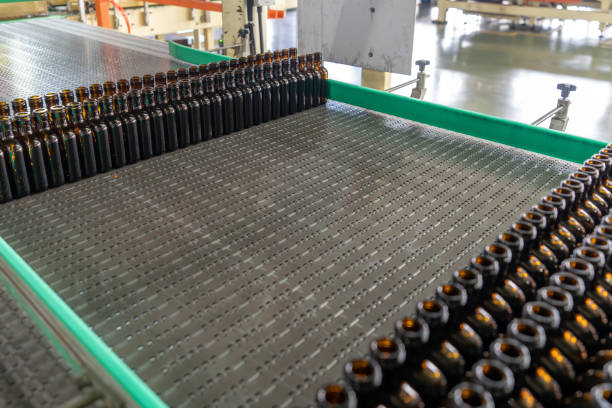 neat brown glass bottles on the production line of the glass factory