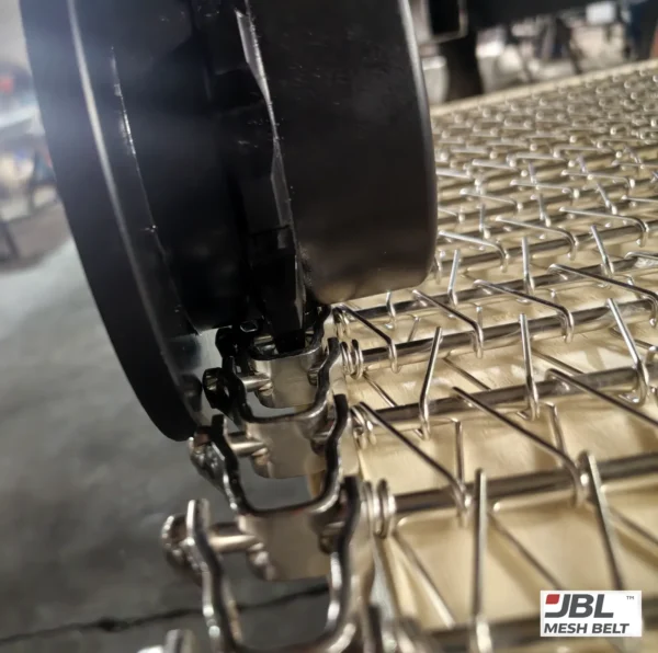Spiral belt sprocket teeth engaging the edge links before shipment