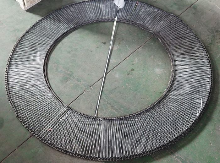 JBL Mesh Belt spiral belt laid in a circle with a tape measure across the inside opening