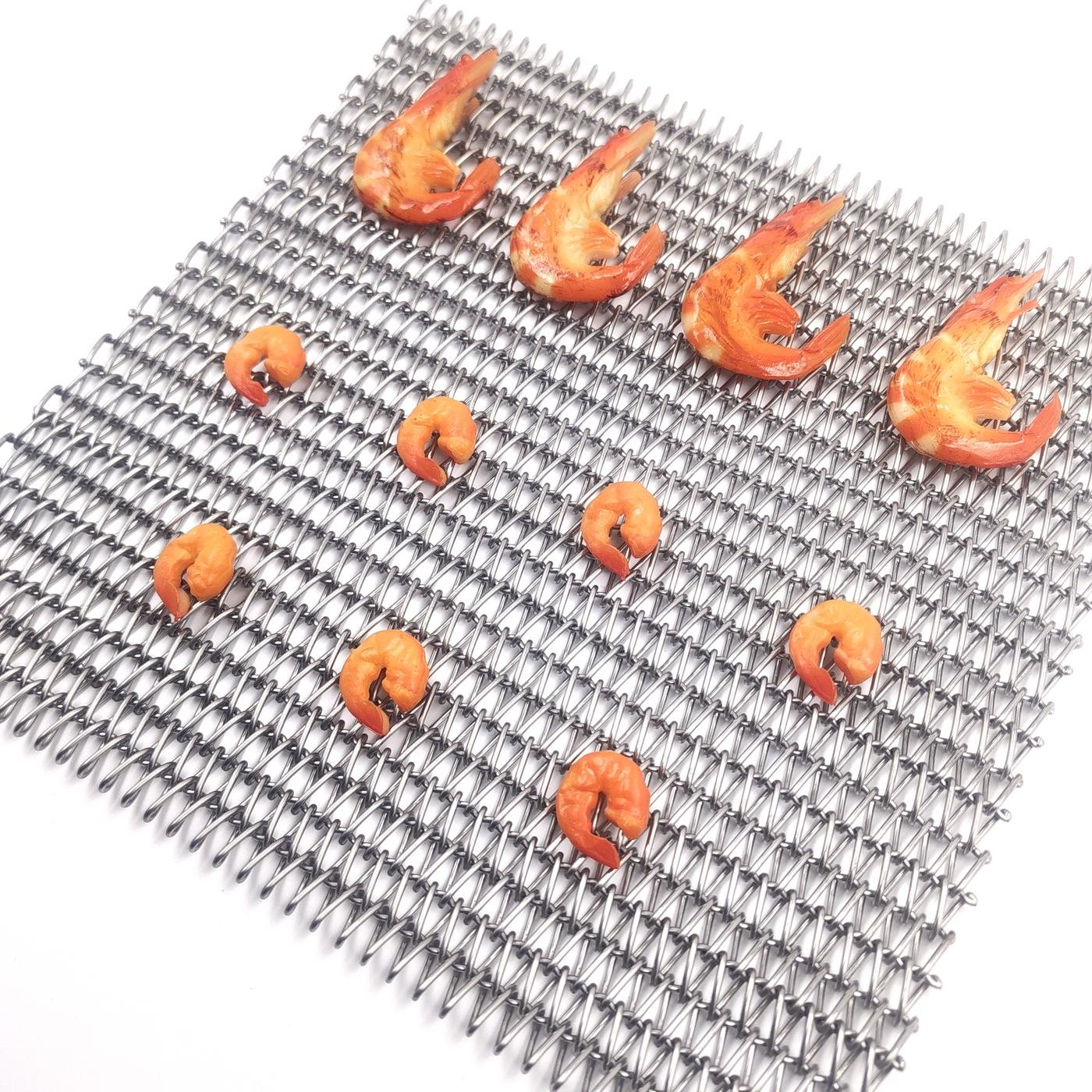 JBL Mesh Belt - Seafood on a metal belt surface